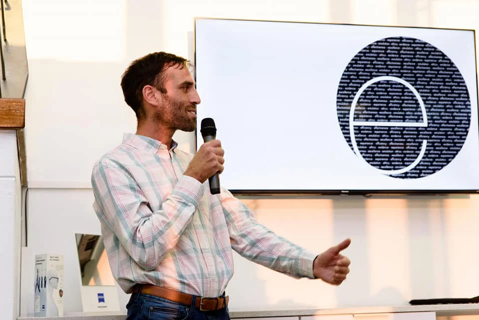 Dr David Huson presenting, with the Bio-Emulation emblem on screen behind him